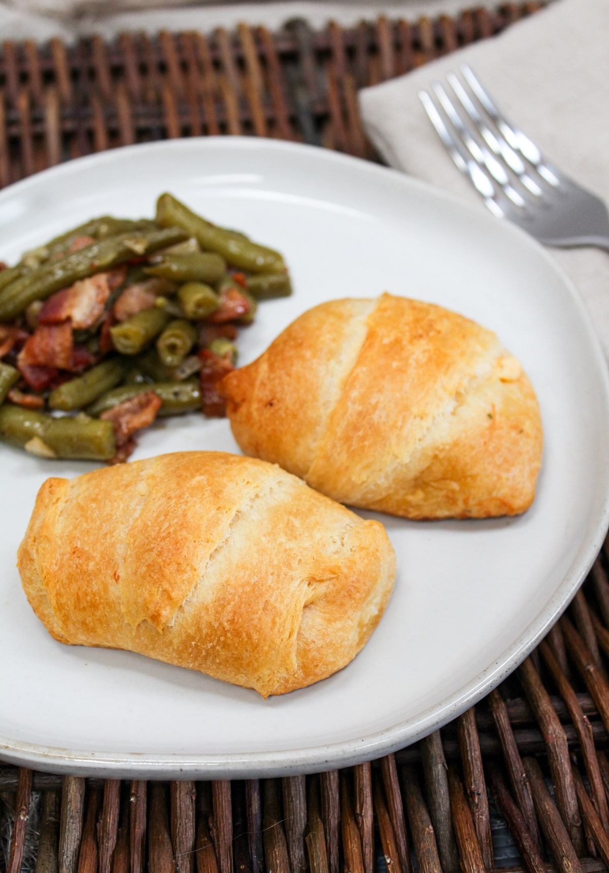 plated chicken crescent with green beans on the side