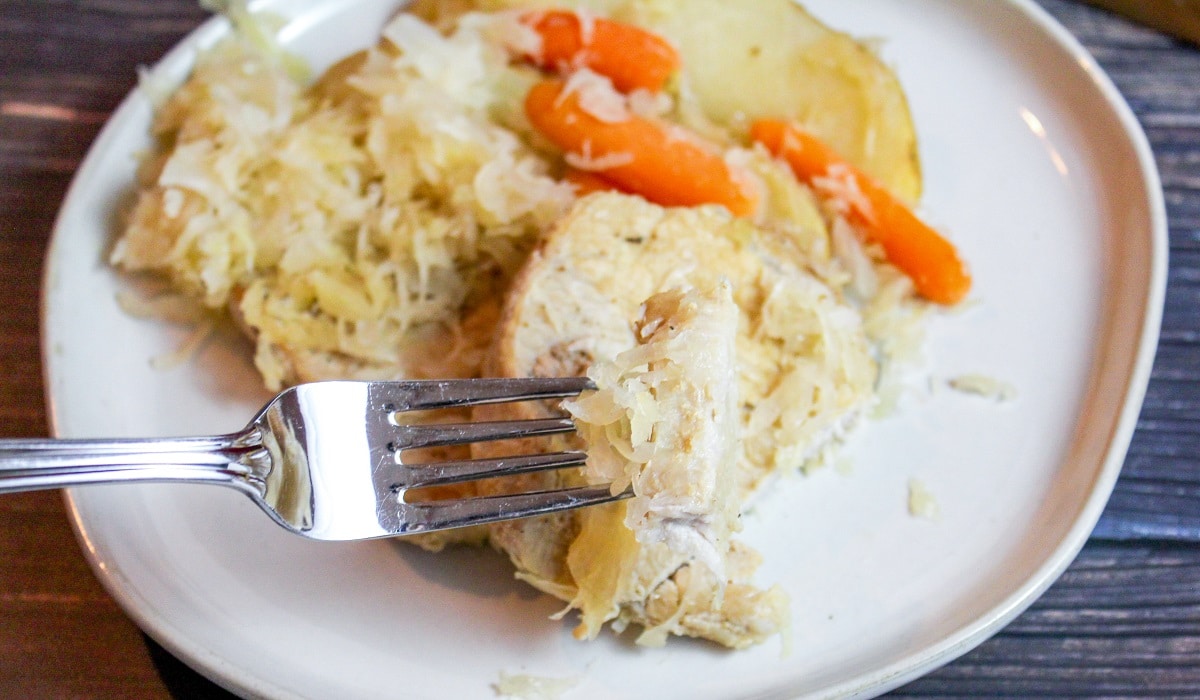 pork chops with sauerkraut on a plate with a fork