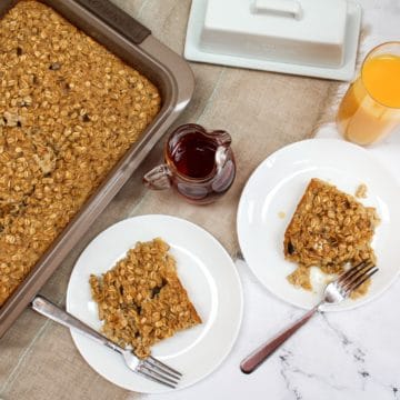 overhead photo of oatmeal in baking pan and two plated white dishes