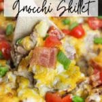 Bacon Cheeseburger Gnocchi Skillet in cast iron skillet scooped with a spoon