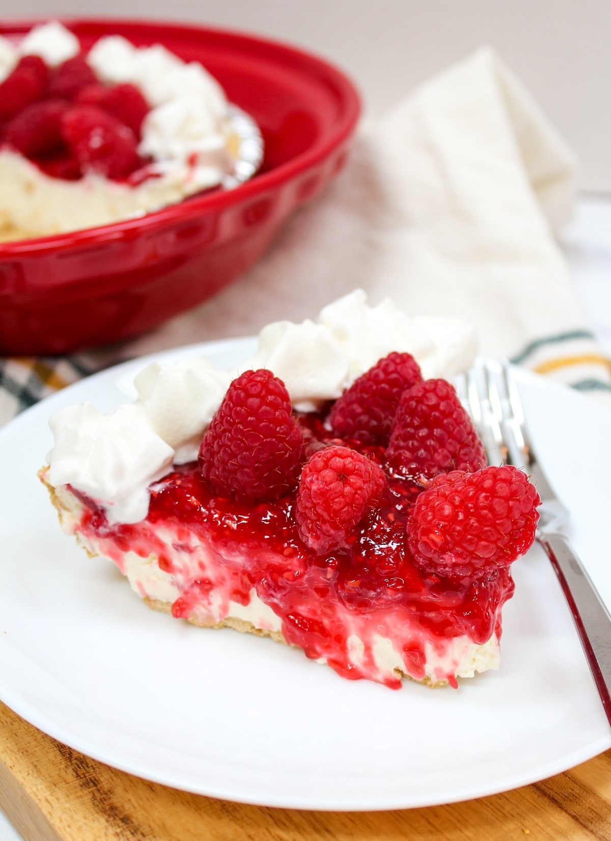 raspberry cream pie on a plate with fork