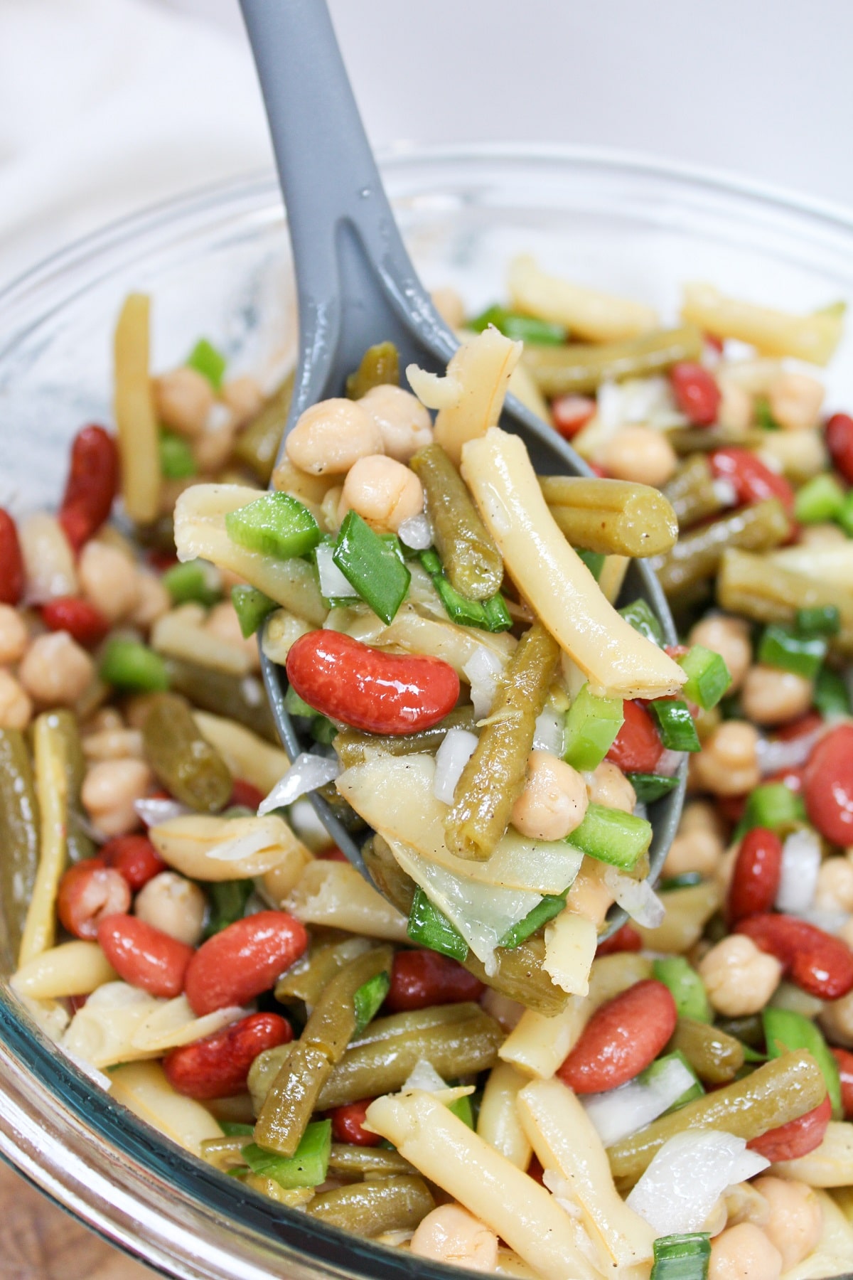 classic 3-bean salad scooped from the bowl on a spoon