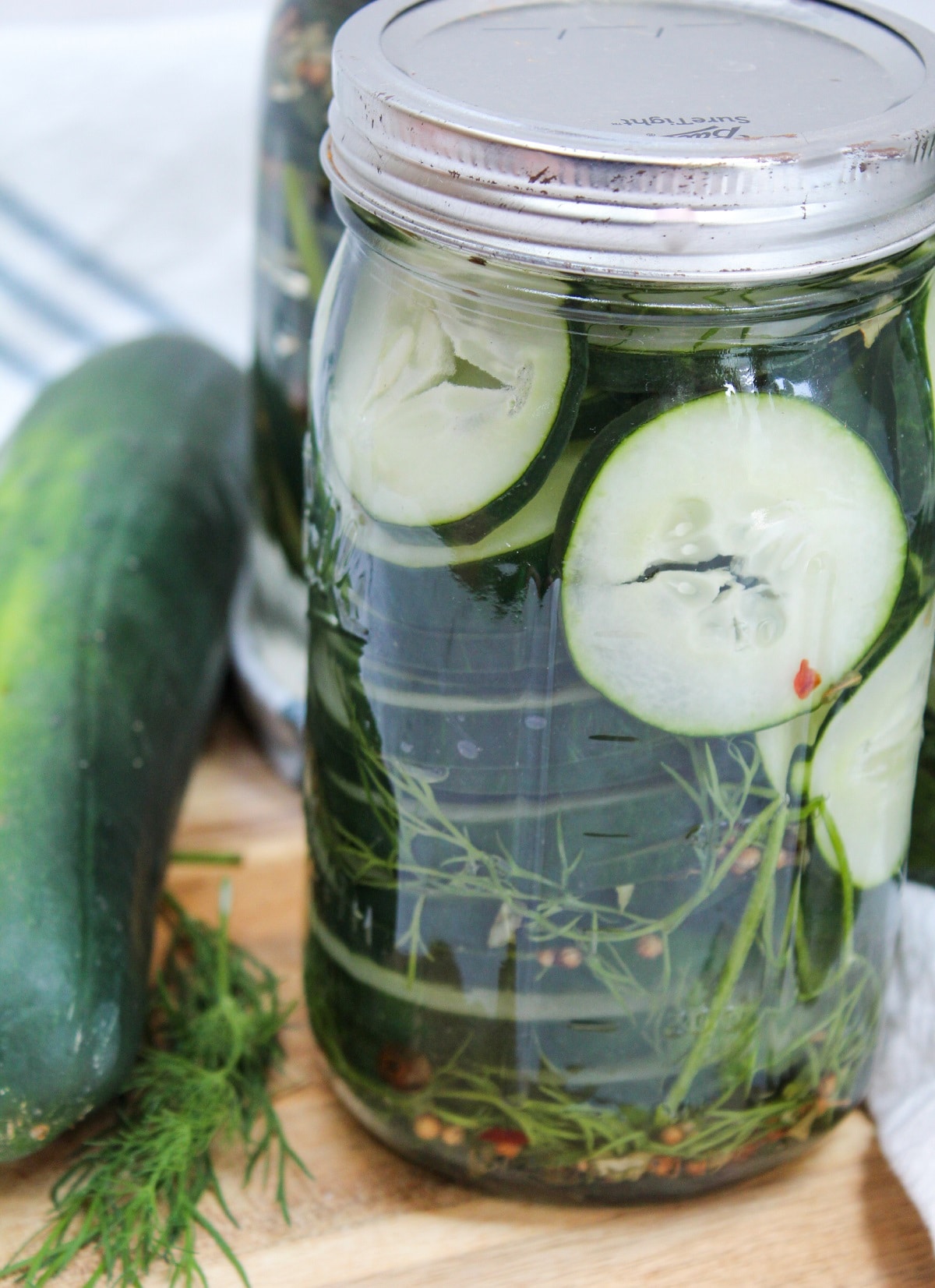 sliced easy refrigerator dill pickles in a sealed glass jar