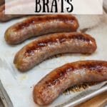 oven baked brats on a baking sheet