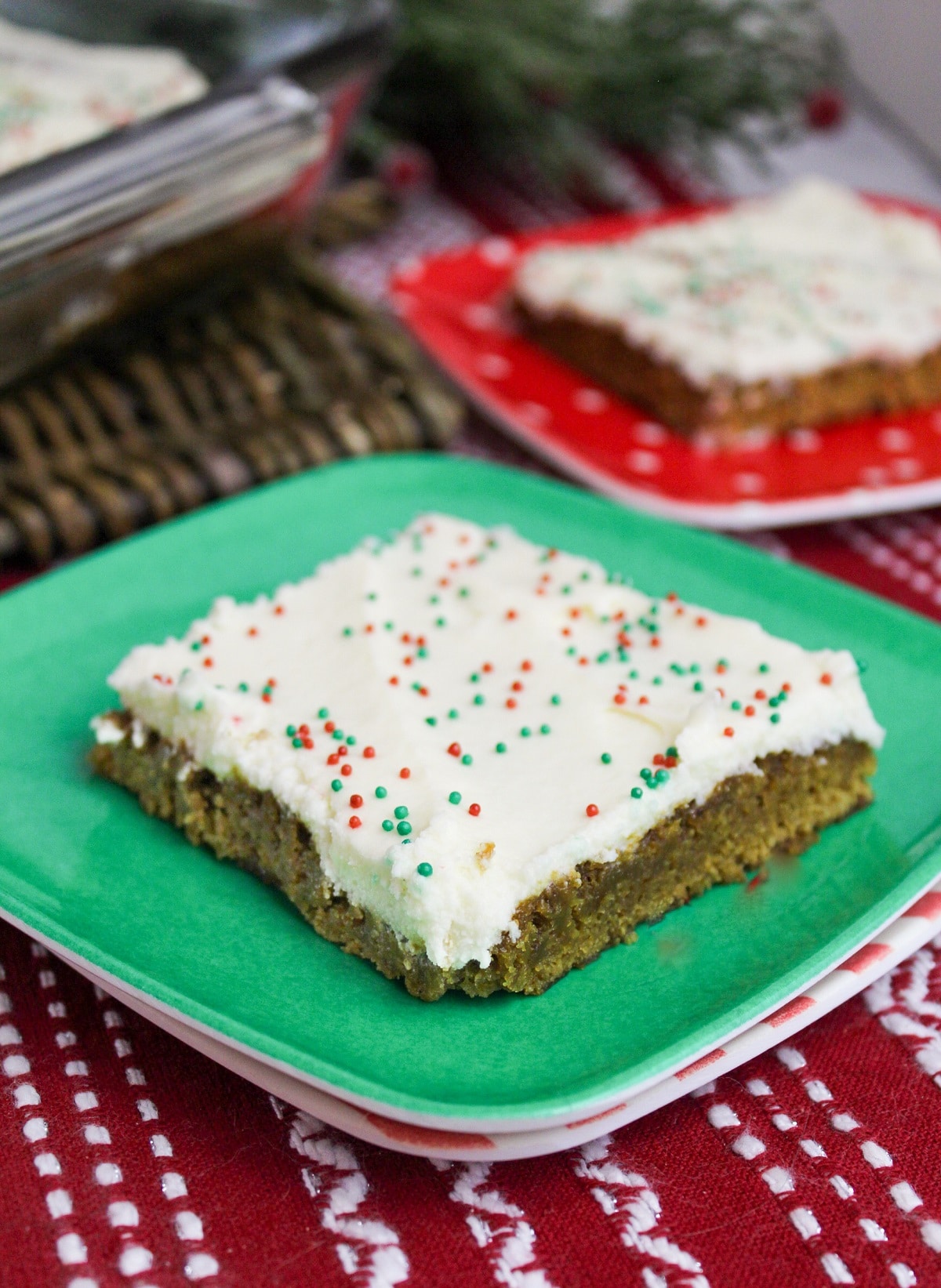 gingerbread cookie bar cut into a slice on a green plate