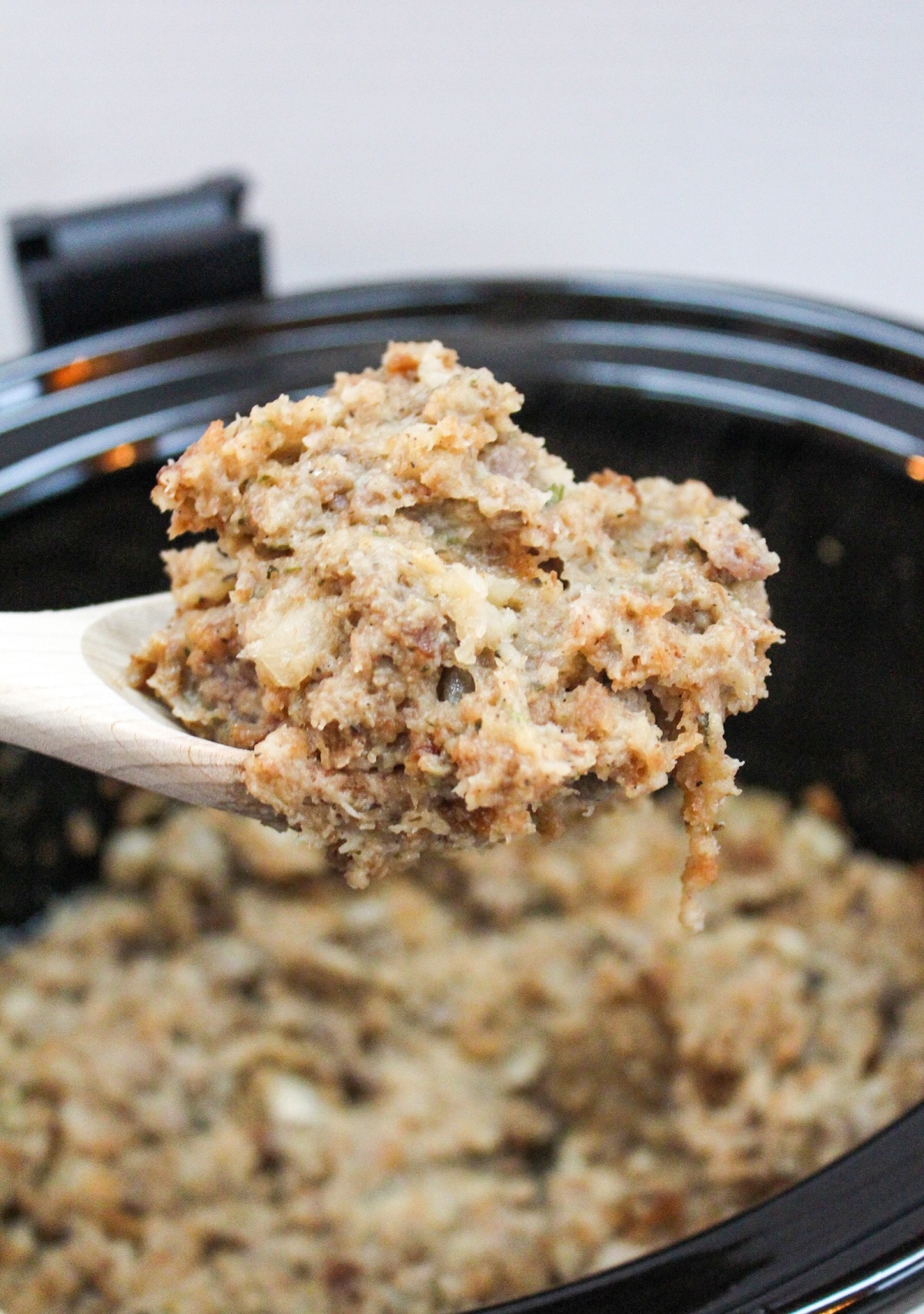 slow cooker sausage stuffing on a spoon