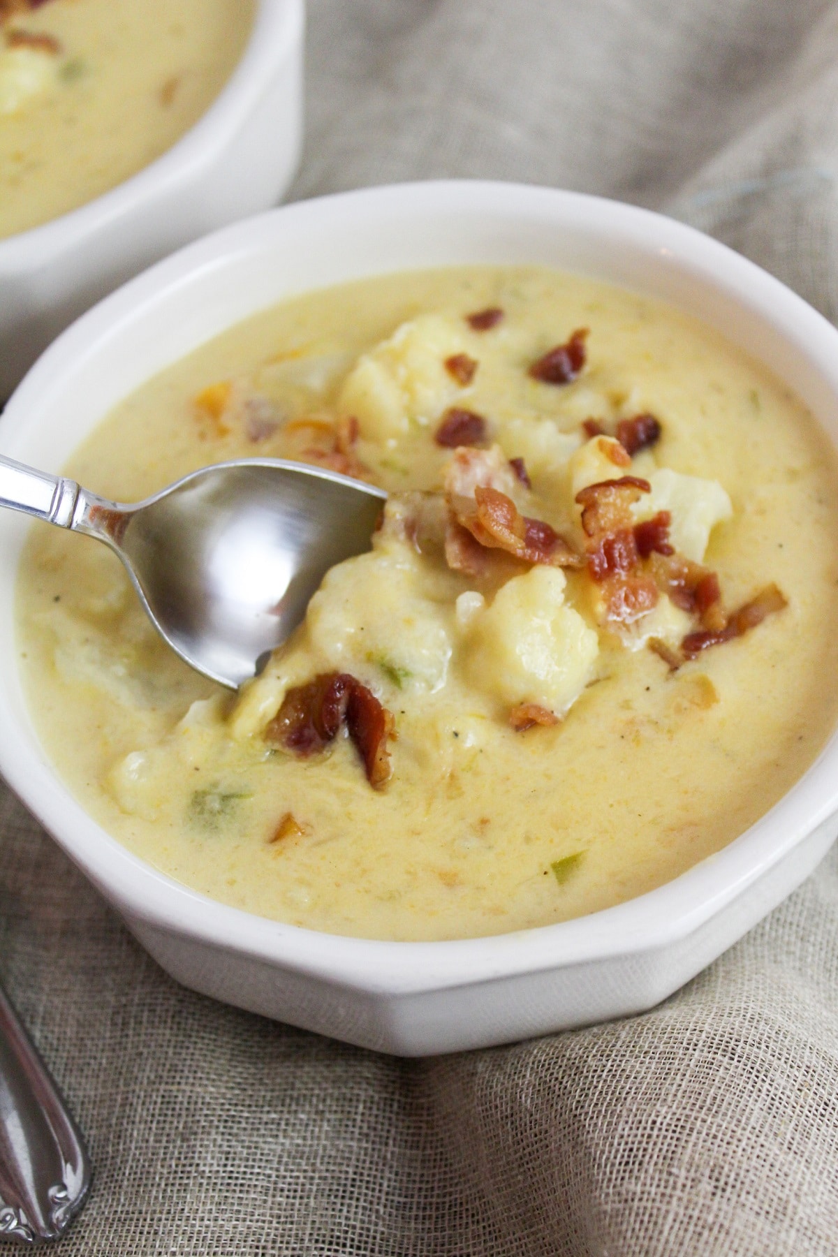 Cheesy cauliflower soup with spoon