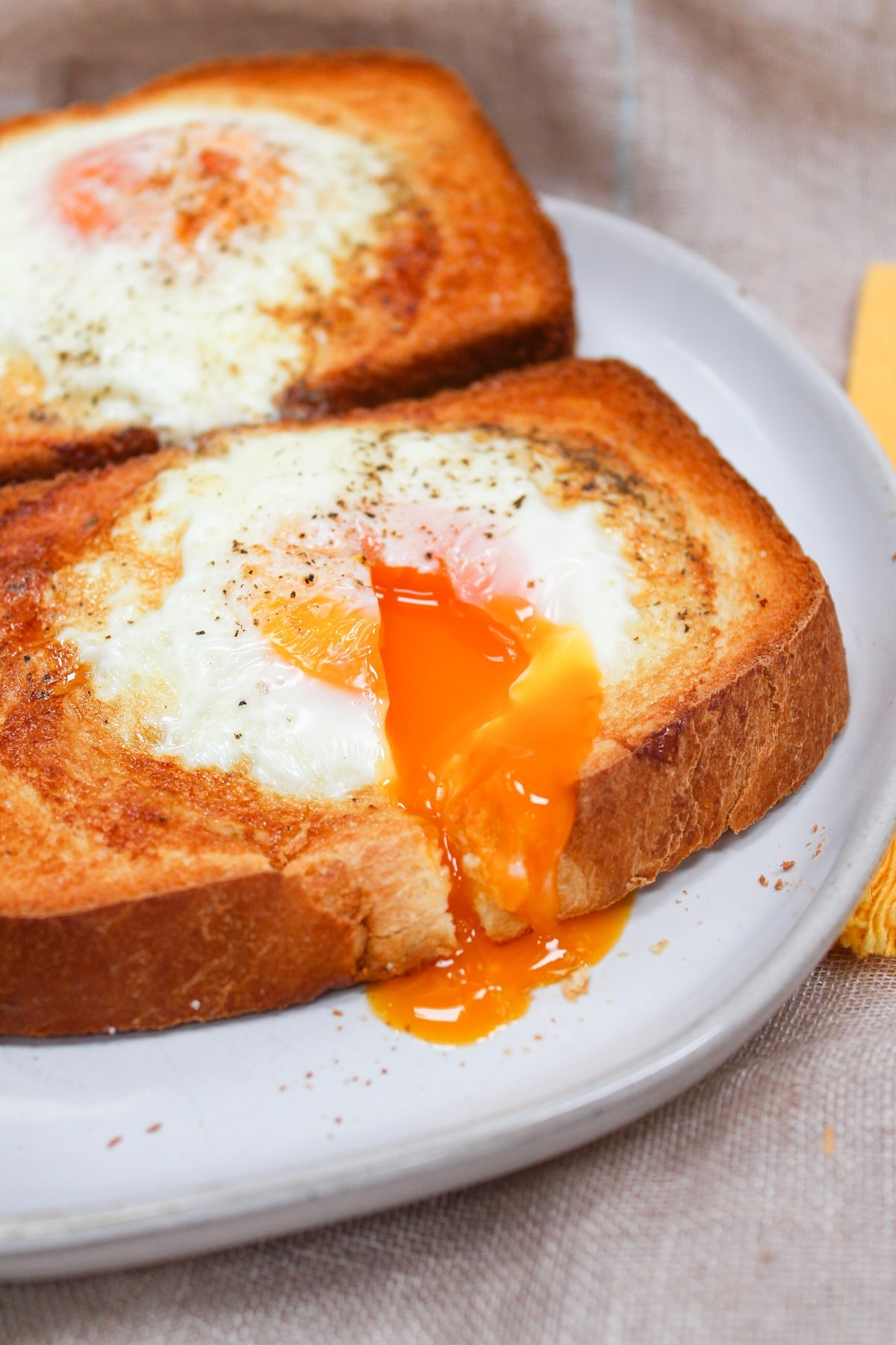 air fryer egg toast on a plate with yolk broken