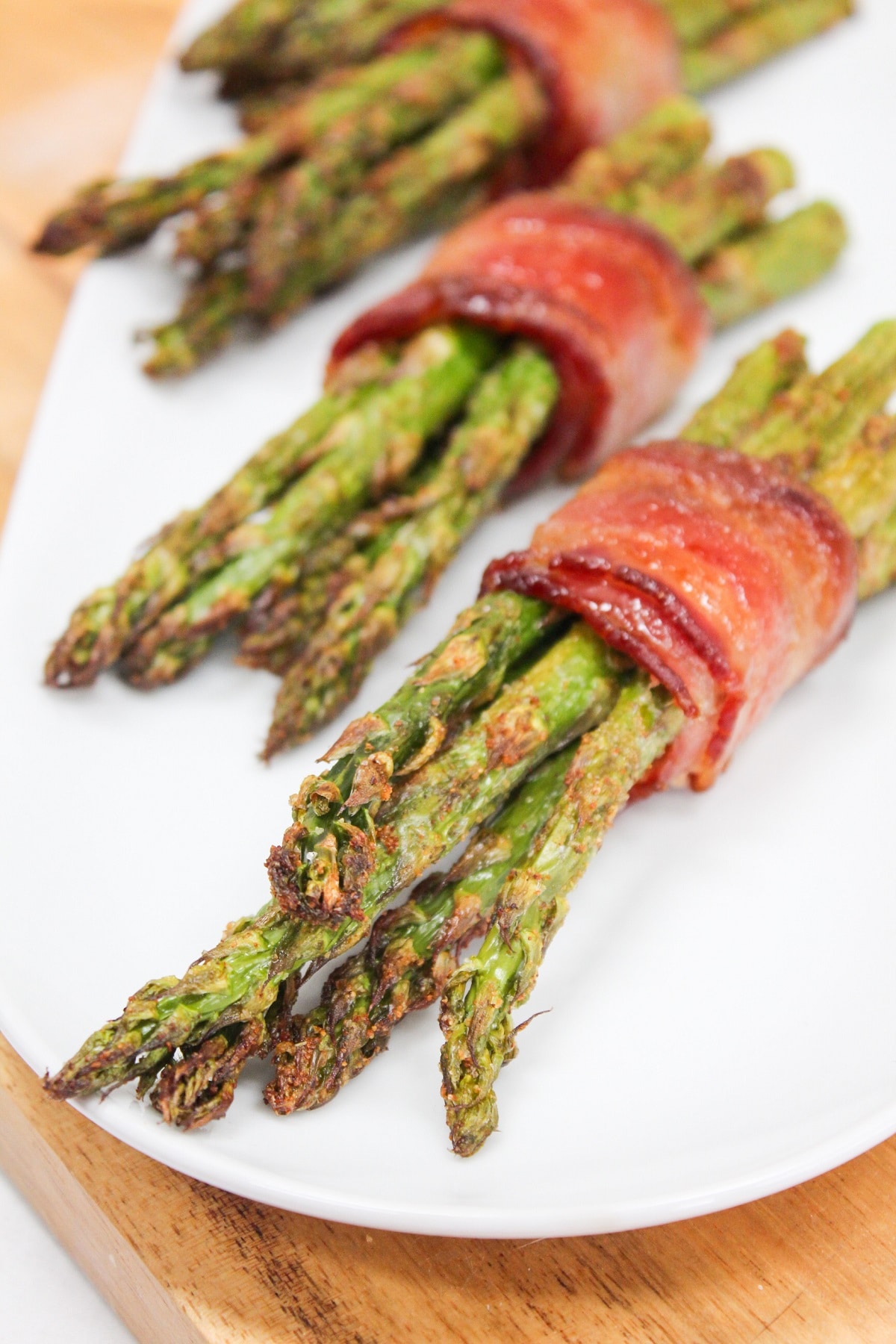 air fryer bacon wrapped asparagus on a plate.