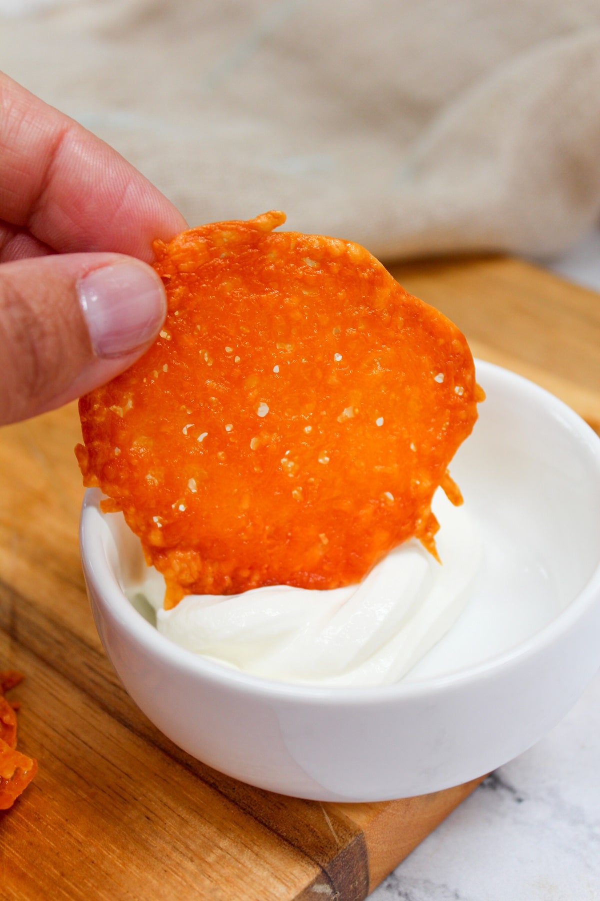 cheddar cheese crisp dipped in sour cream