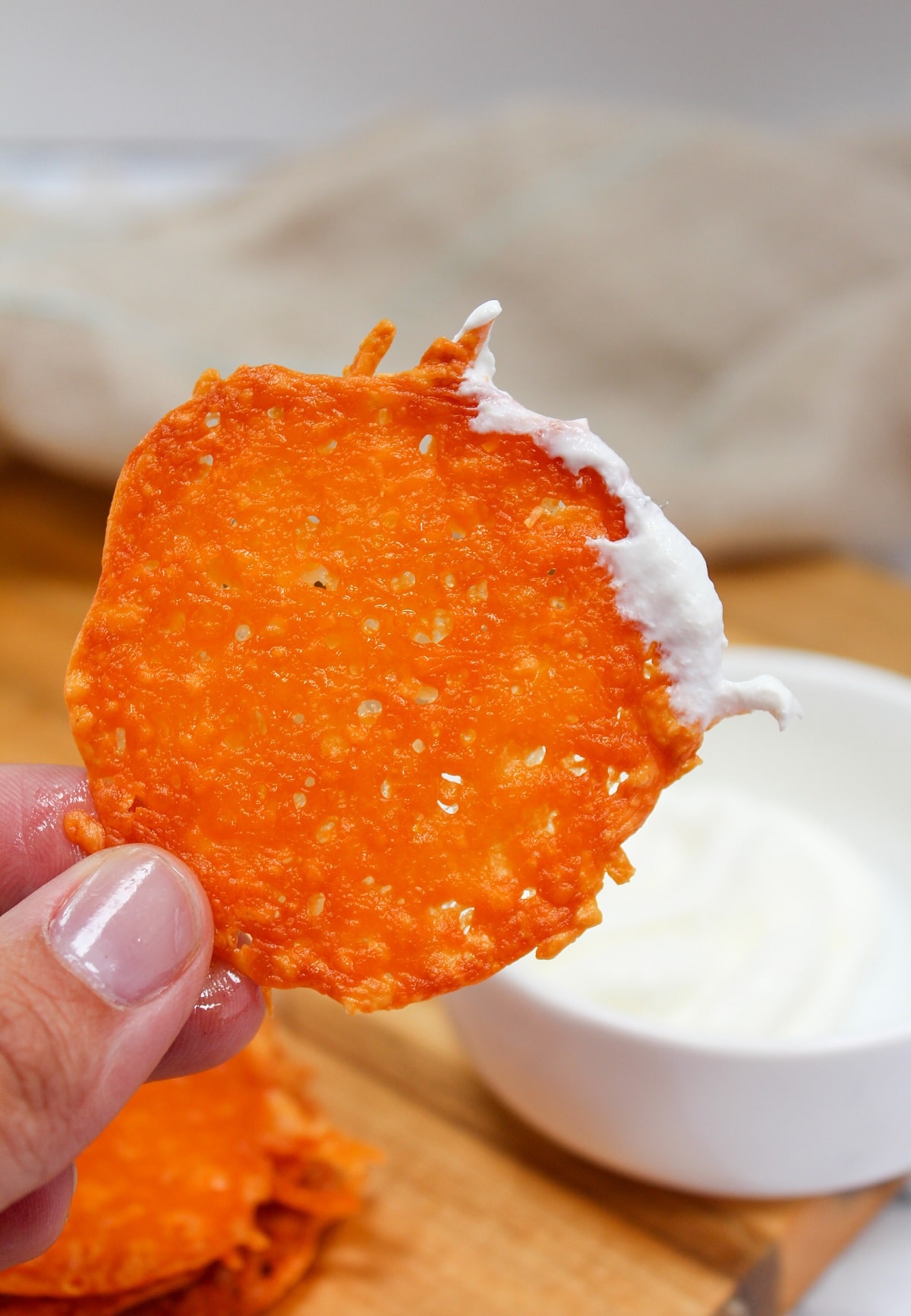 cheddar cheese crisp dipped in sour cream