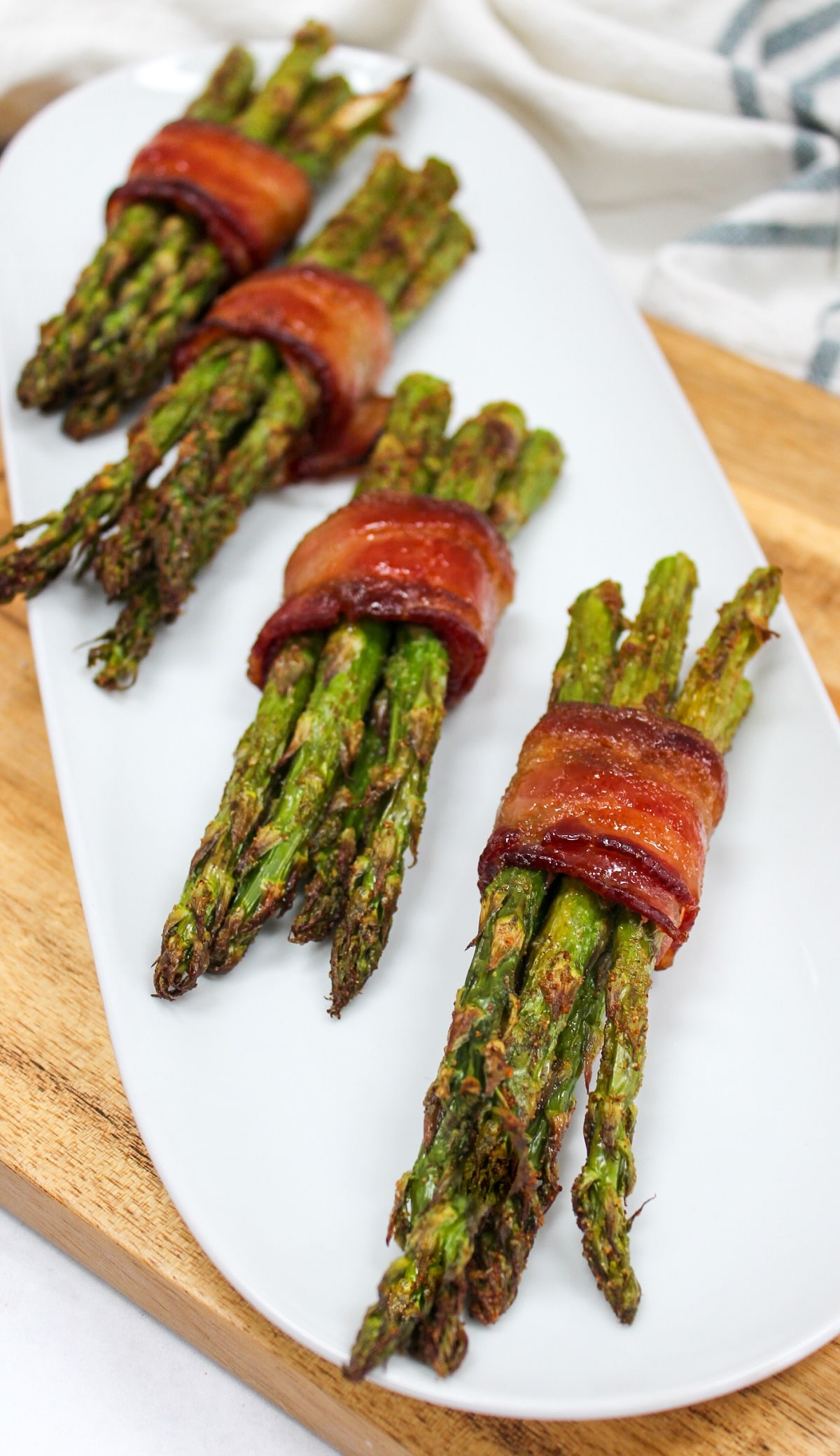 air fryer bacon wrapped asparagus on a plate.