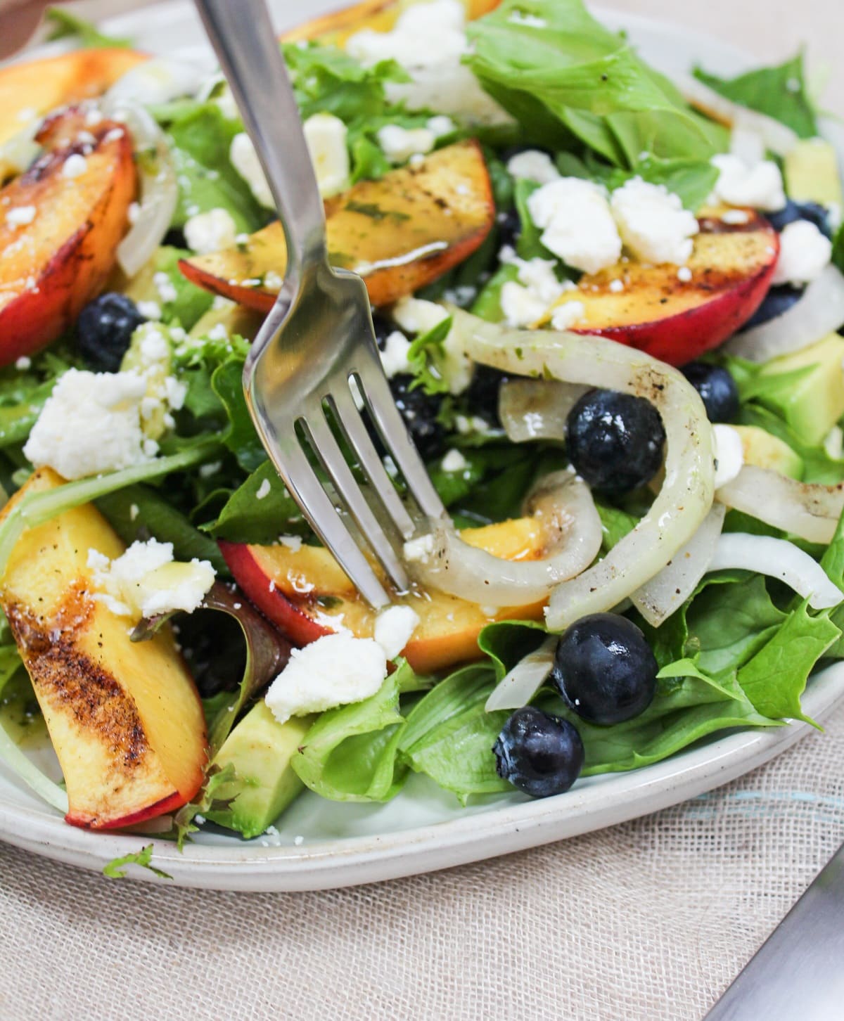 Grilled Summer Peach Salad on a fork.