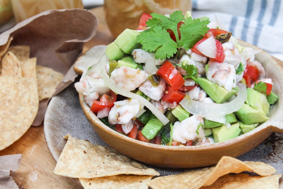 shrimp ceviche in a bowl with tortilla chips on the side