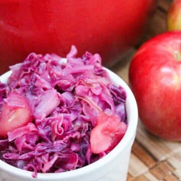chopped red cabbage and apples in a small white dish.