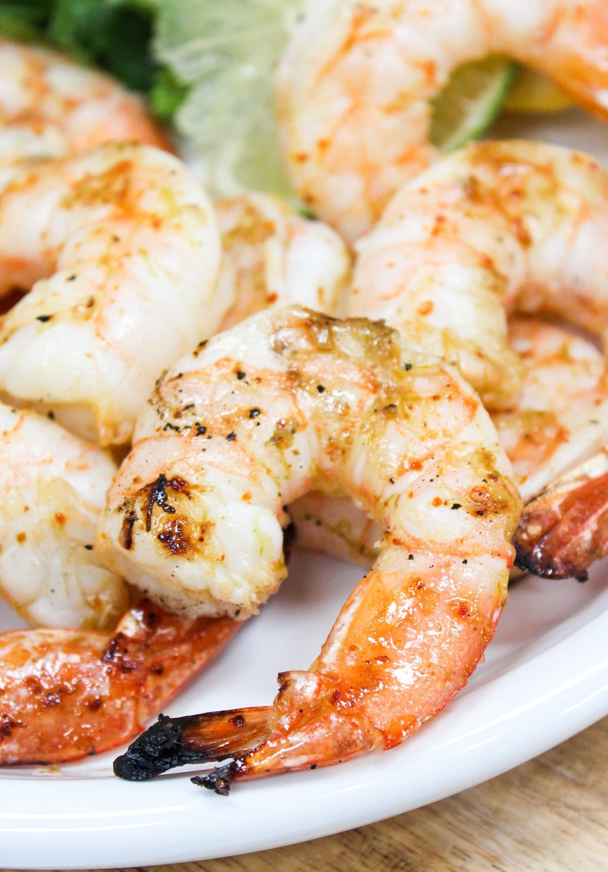 Grilled shrimp on a white plate.