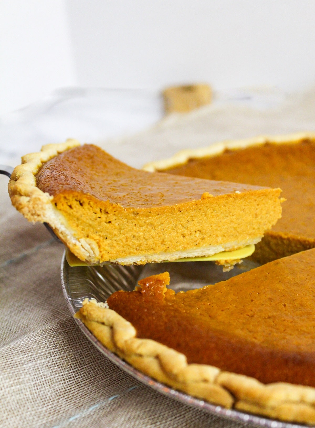 Slice of pumpkin pie lifted from the dish.