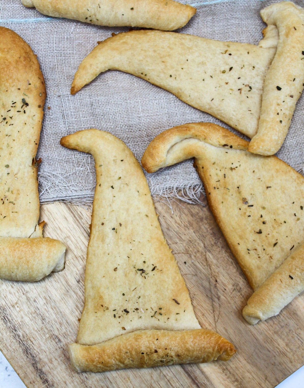 crescent rolls shaped like witch hats topped with chopped parsley.