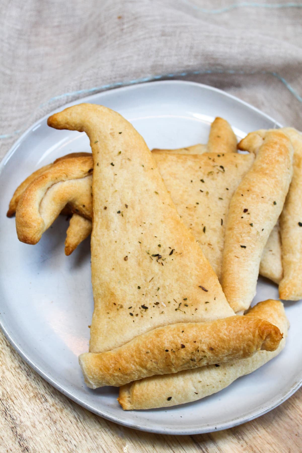 crescent rolls shaped like witch hats topped with chopped parsley.